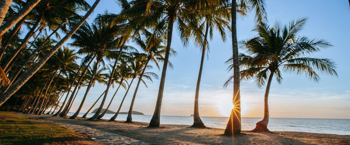 Cairns showing a sunset, general coastal views and a beach