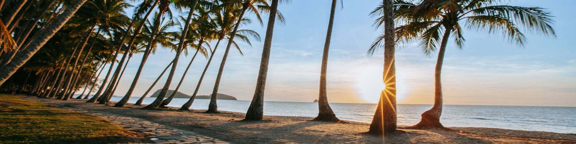 Cairns showing a sunset, general coastal views and a beach