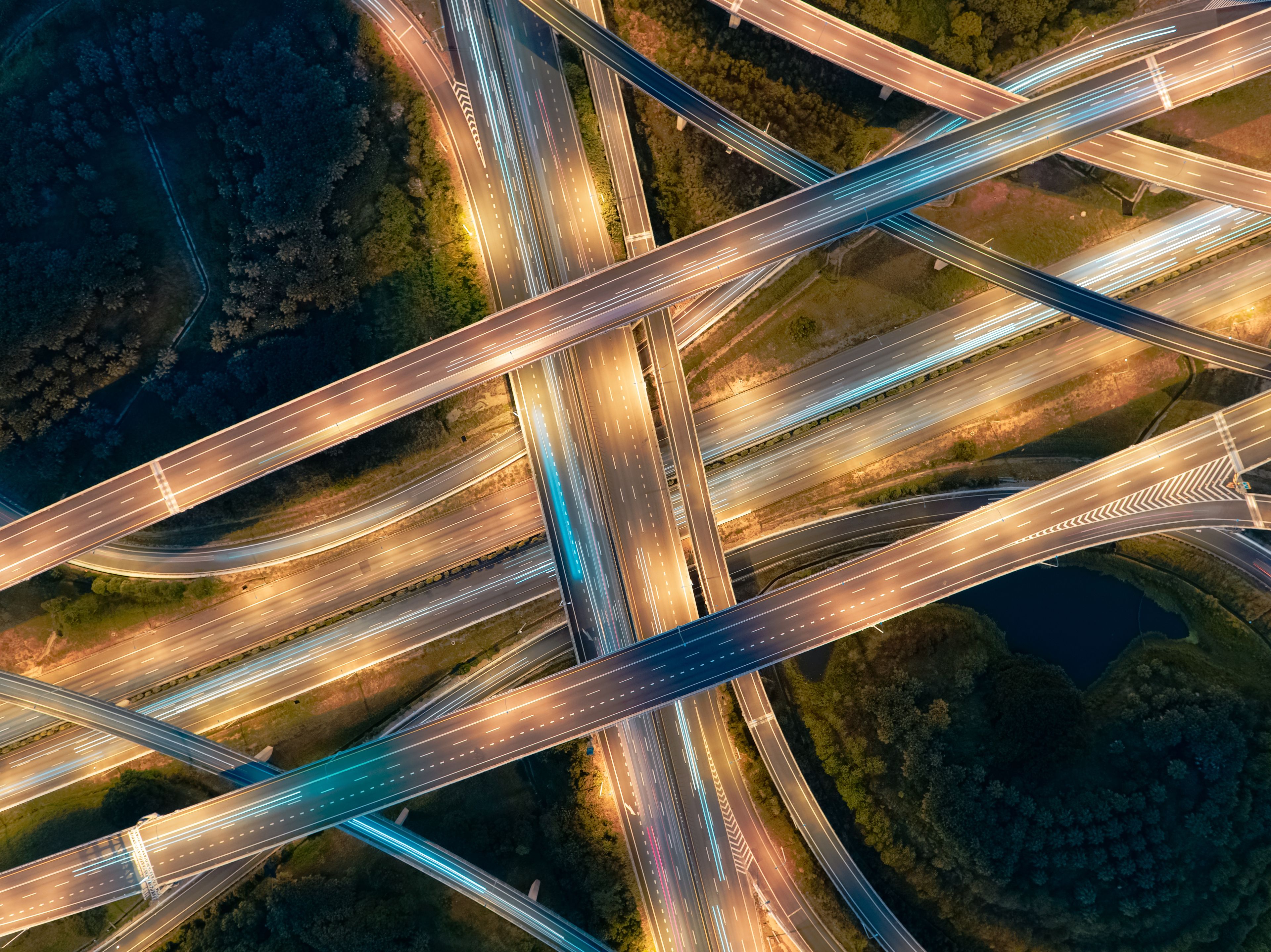 An aerial view of a complex highway interchange with multiple overpasses and traffic flow.