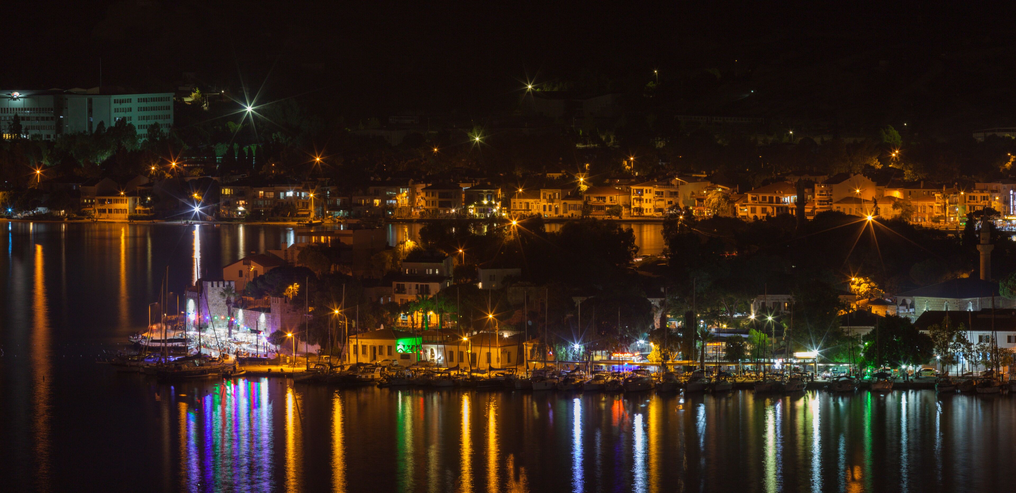 Nice night view of old Phokaia (in TR: eski foca) located in Izmir, Turkey. Great reflections of lights over the sea. Night cityscape concept. Reflection in the sea.
