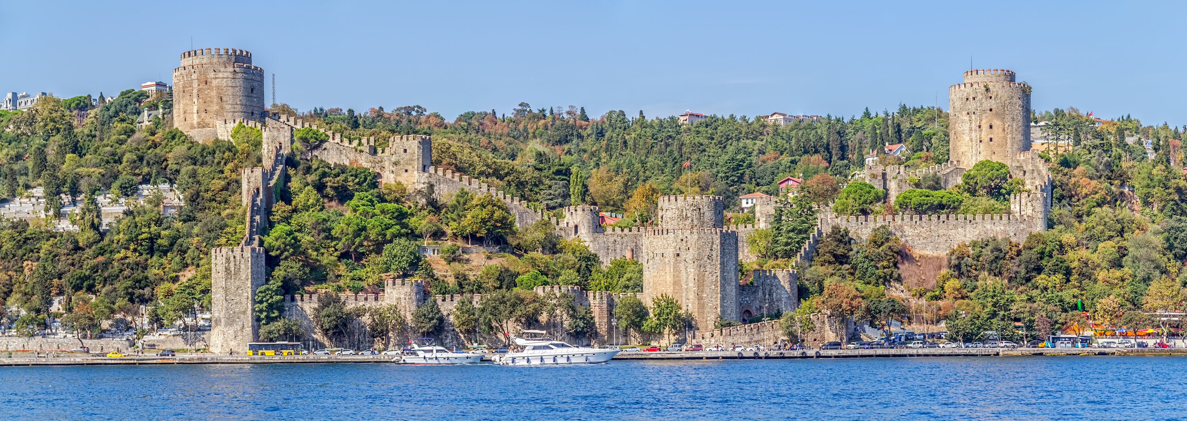 A coastal city with historic stone fortifications and a marina.