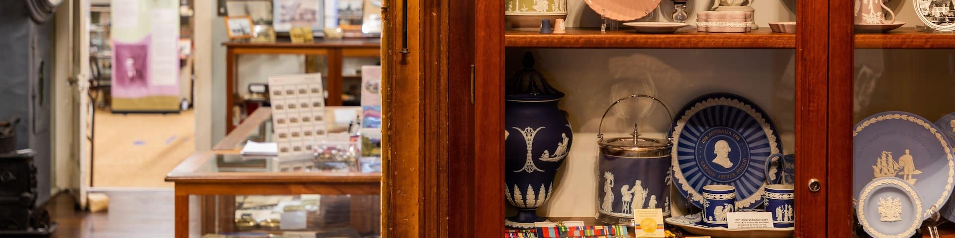 A display of vintage china and porcelain in a shop.