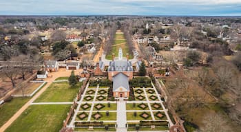 View of Governor's Palace featuring lush gardens and trees in Colonial Williamsburg in Virginia
