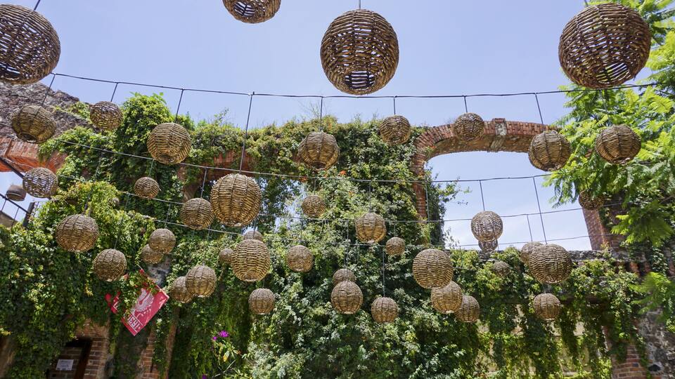 Park decorated with decorative straw balls in Val'Quirico, Mexico
