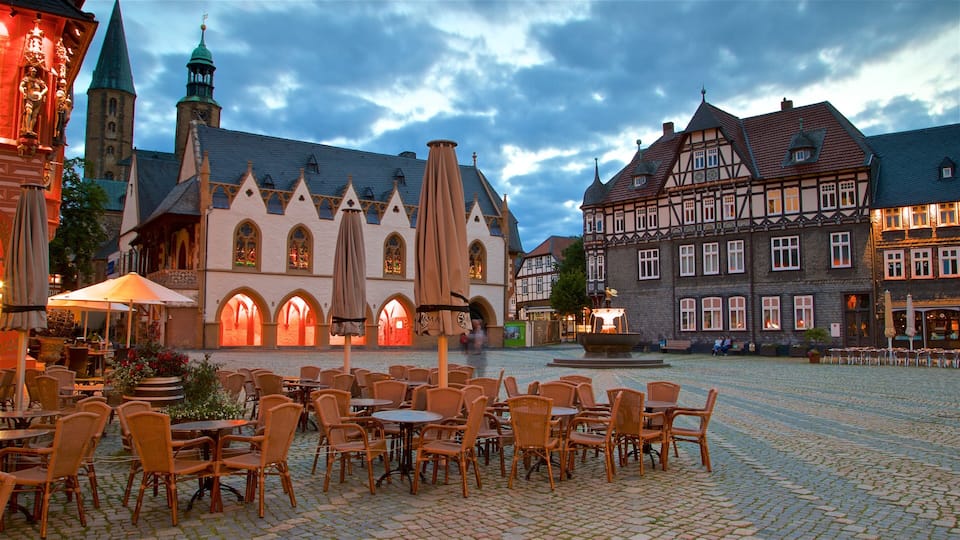 A cobblestone square with outdoor seating and historic buildings.