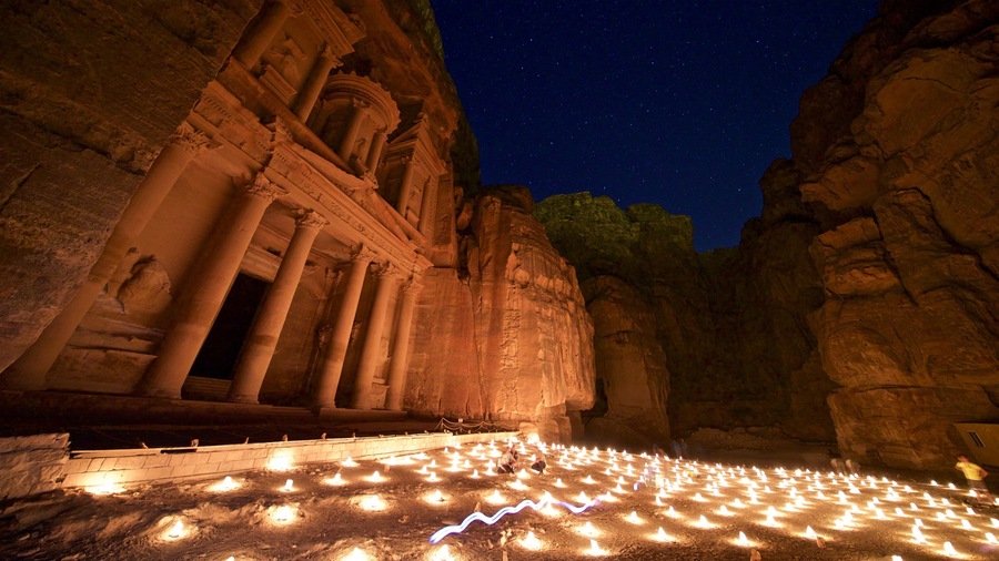 Wadi Musa which includes heritage architecture, a gorge or canyon and night scenes