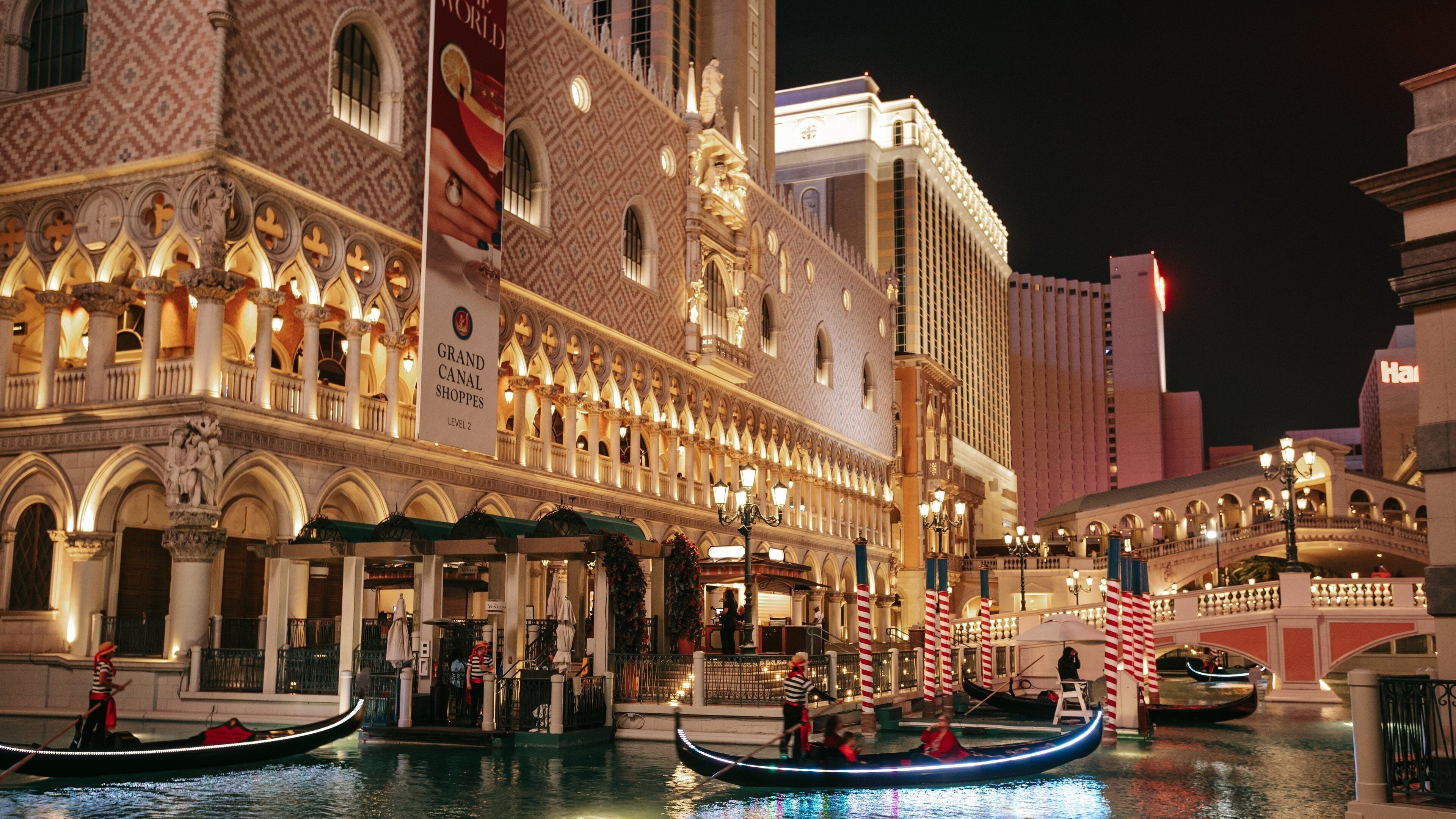 The Venetian Casino showing night scenes, kayaking or canoeing and a city