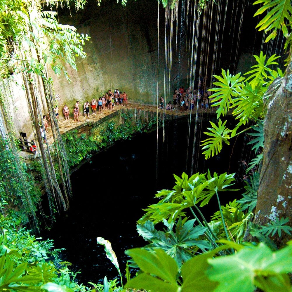 The line is long to jump off the rock platform at cenote Ik-Kil. This well-loved sinkhole is a super fun visit--the water is like silk, exotic vines climb the walls and little black fish swirl in schools, sometimes nudging the odd arm or leg. Our favorite trick? Rent a car and arrive at 4/4:30 when all the tour buses are just pulling out. That still leaves ample time to swim and float (park closes at 5) and there are far less people. 70 Peso entrance fee includes onsite bathrooms and changing areas. Makes for fabulosity when combined with an overnight in Valladolid. • http://www.cenote-ik-kil.com • #Yucatan #Mexico #cenotes #swimming