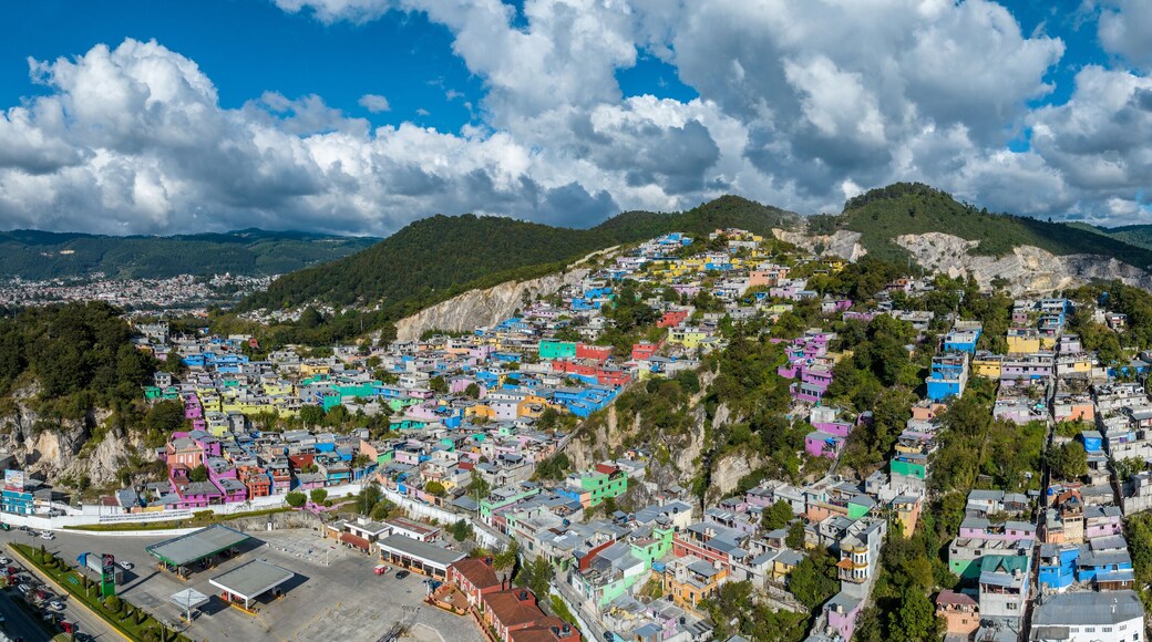 Aerial view of colorful mountain village of San Cristobal de Las Casas in Mexico. Clouds over the mountains. Panorama.