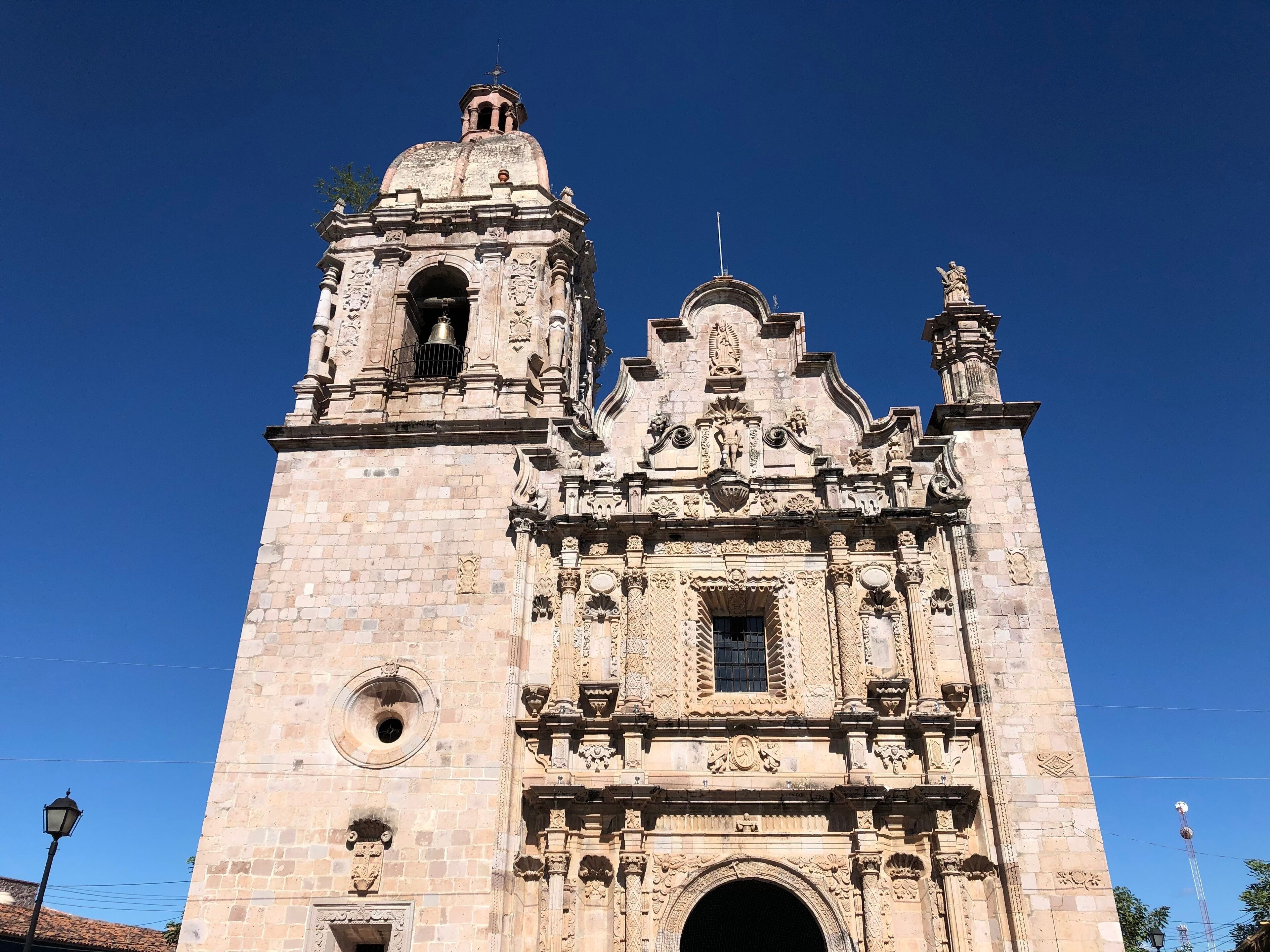 A historic church with intricate stone carvings and a bell tower.