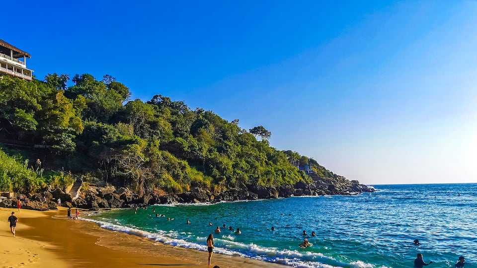Beach sand blue water huge surfer waves Carrizalillo Puerto Escondido.