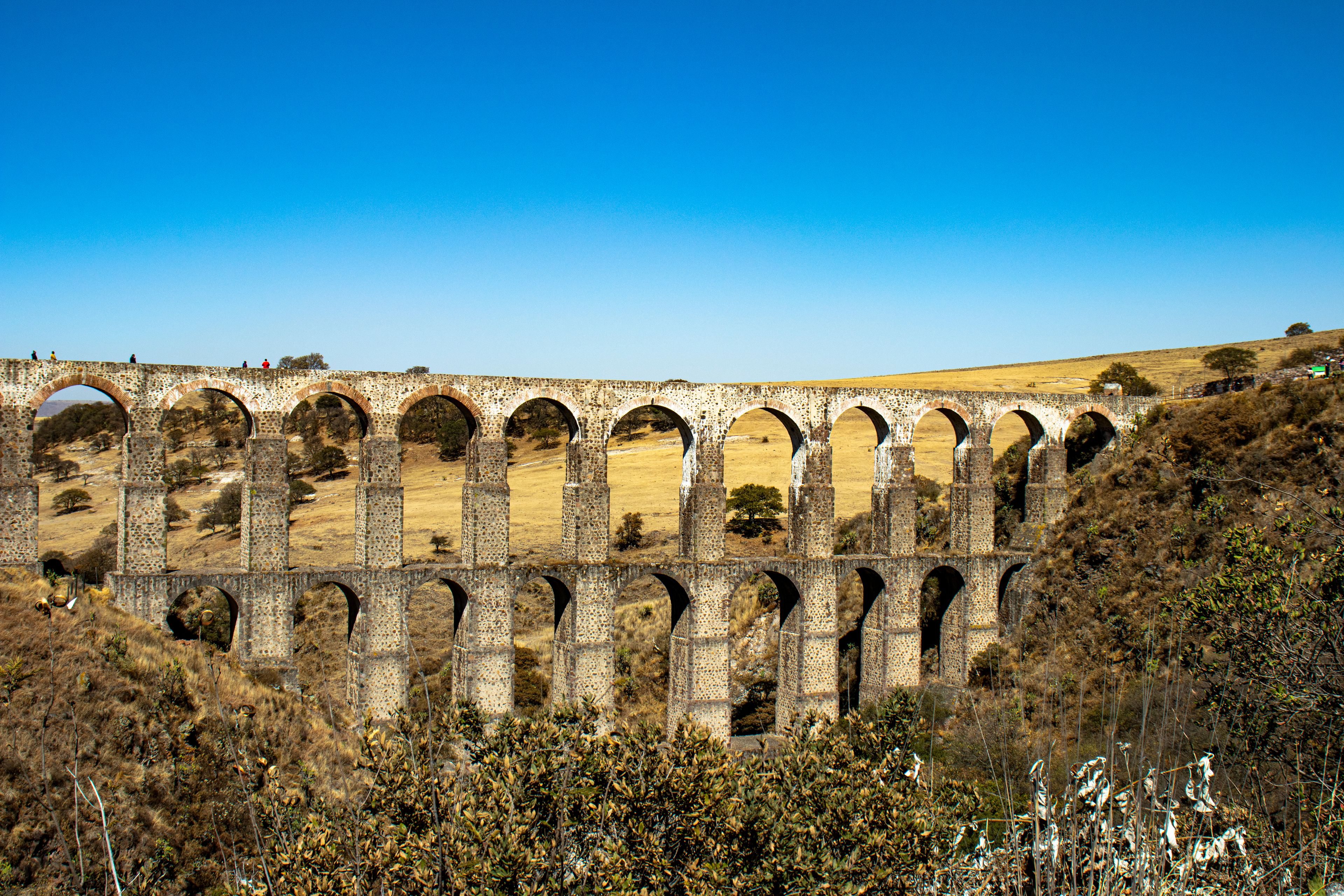 A stone viaduct with multiple arches spanning a valley.