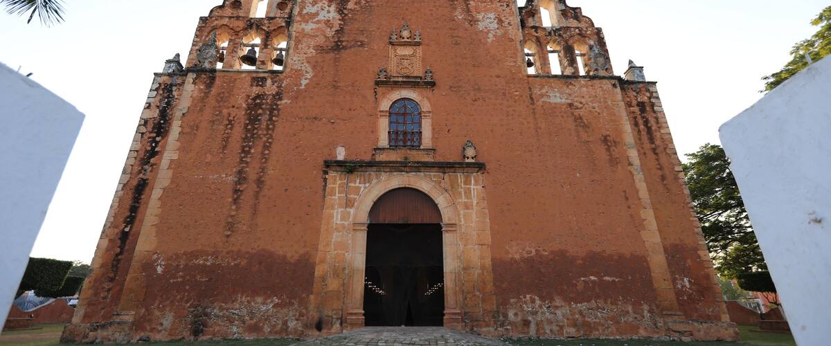 A large, historic church with a prominent arched entrance and multiple bell towers.
