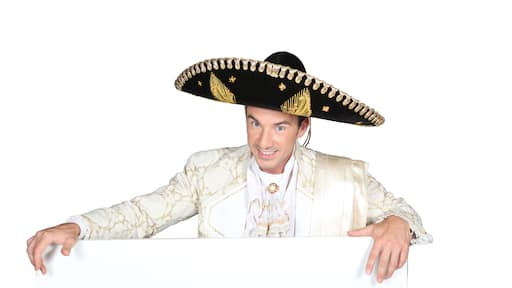Man in a mariachi costume with board for message