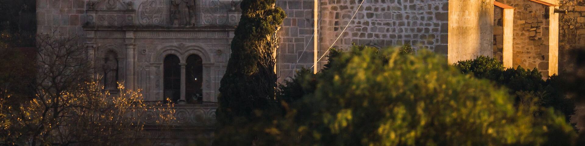 Main church of the Municipality of Charo Michoacan, with the sunlight hitting it laterally at sunset, with the mountains behind it.