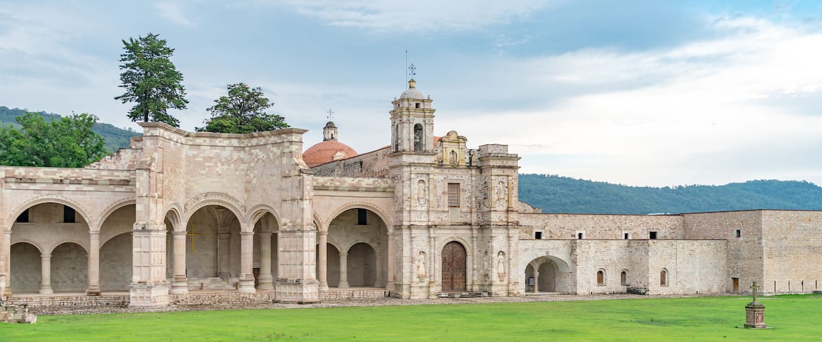 A historic building with arches and a tower.