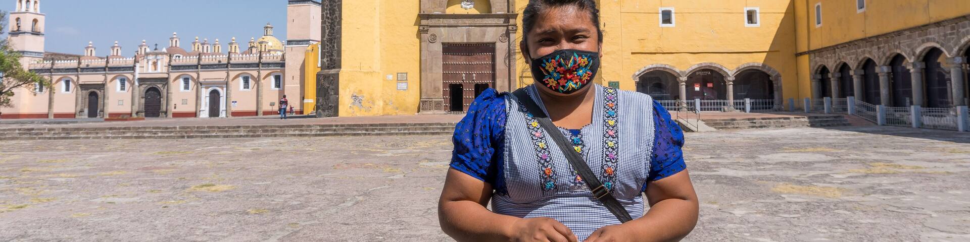 A Hispanic female standing at tThe Convent of San Gabriel Arcangel in Cholula, Mexico