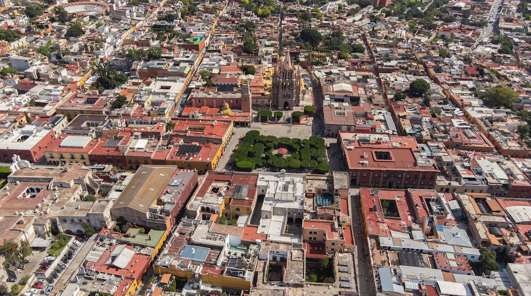 the church Parroquia Archangel Jardin Town Square Night Tree Decoraciones San Miguel de Allende, México. Parroaquia. Night and morning light in a drone view.