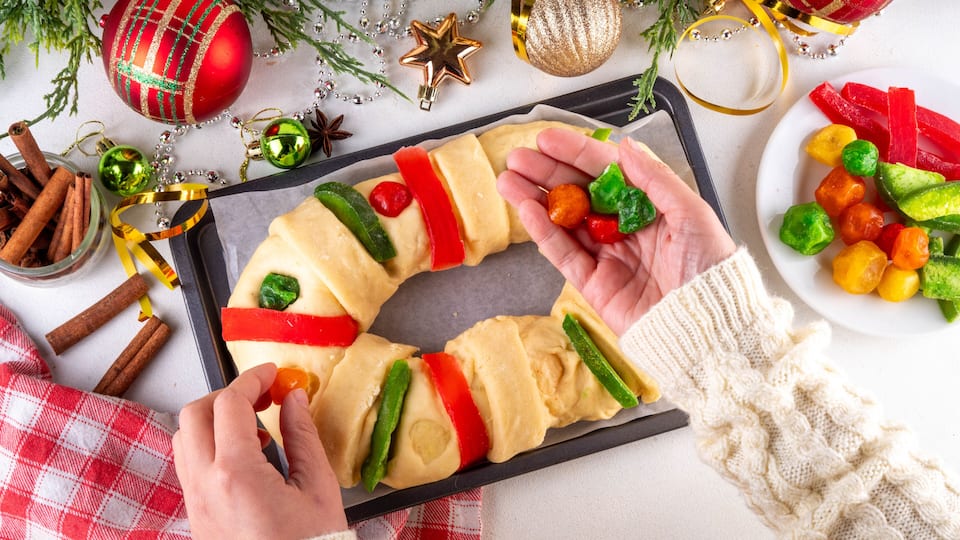 Cooking traditional Mexican Rosca de Reyes, baking for January 6th in honor of Día de los Reyes Magos, Three Kings Bread, fruit flavored sweet bread for Christmas and Kings Day festivities