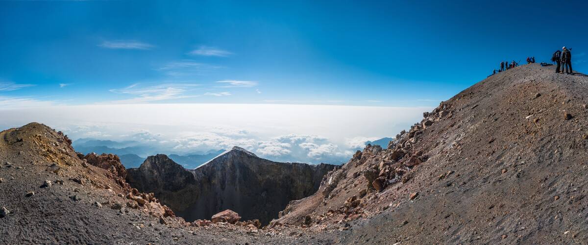 A mountain landscape with rocky terrain and a clear sky.