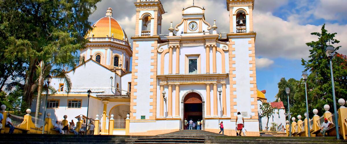 A historic church with two bell towers and a dome.