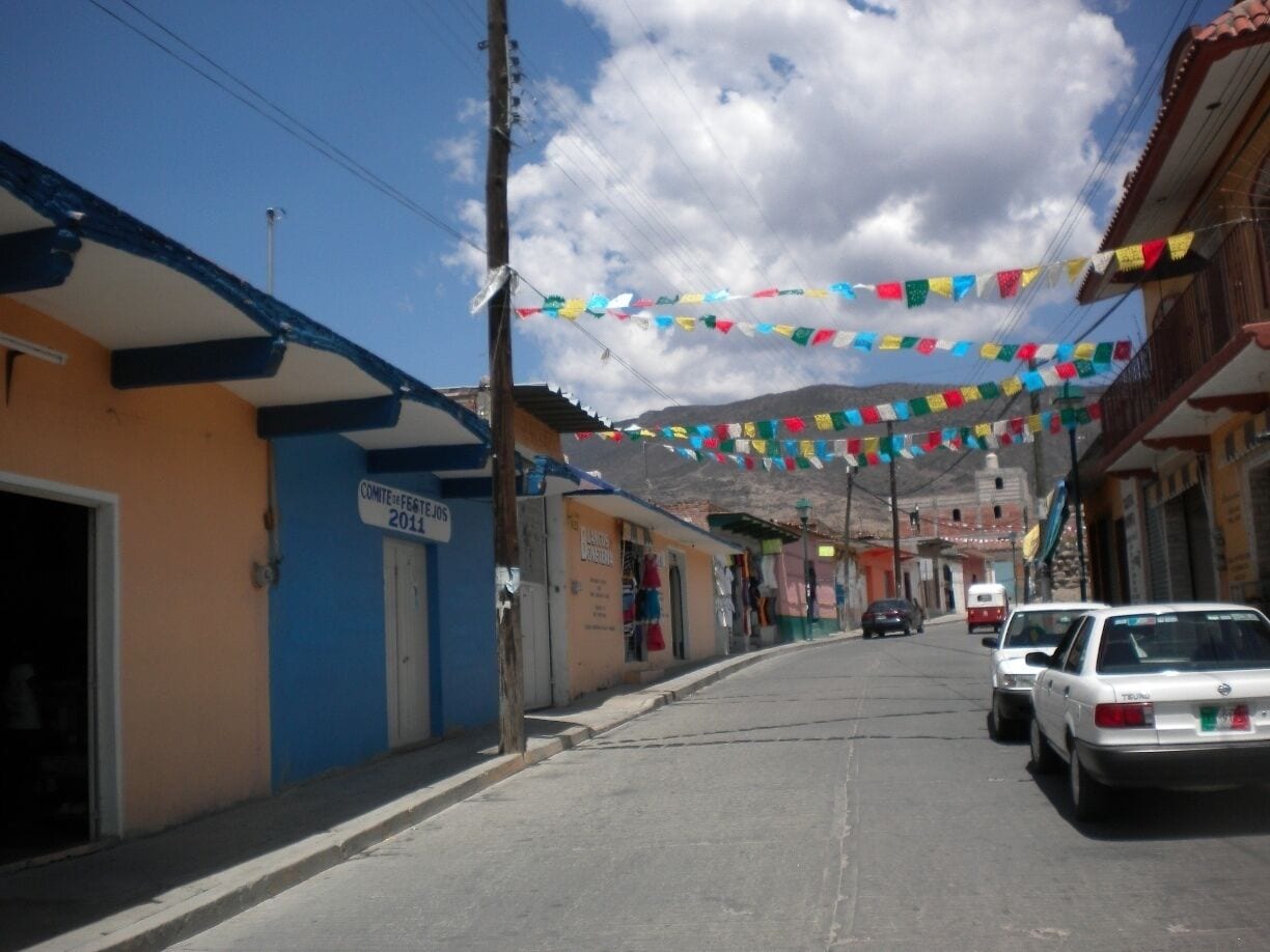 Walking through a the small town of Mitla, Oaxaca on our way to old Zapotec ruins.  El papel picado, the colorful store fronts, and blue sky was an experience.  Nothing special or touristy about it, just breathe-taking.  