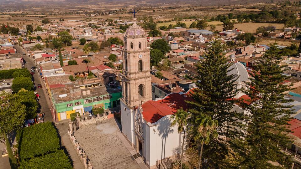 Main Church of Indaparapeo, Michoacán, Mexico, as well as the streets and houses of the town, in the background you can see the mountains of the Sierra Madre Occidental.