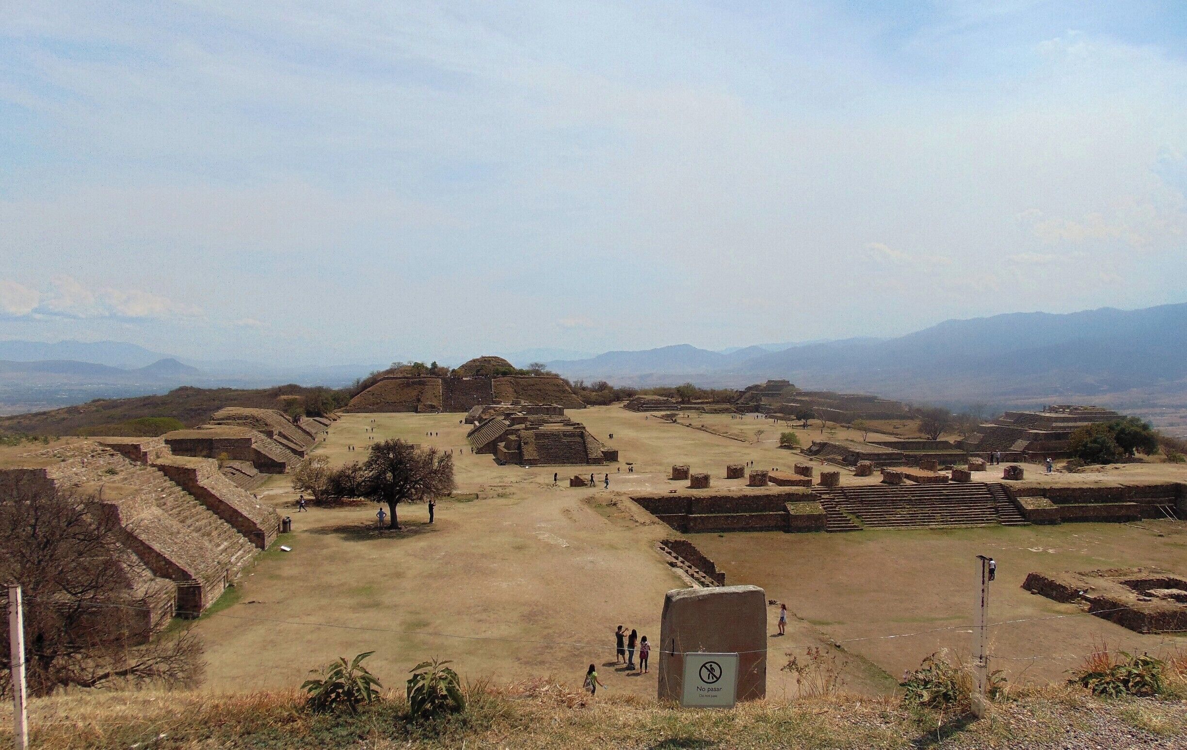 An archaeological site with ancient ruins and a clear view of distant mountains.