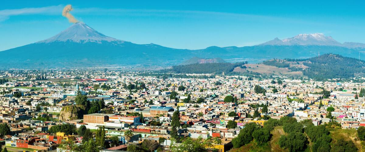 Eruption of Popocatepetl Volcano over the town of Puebla, Mexico, panoramic view
