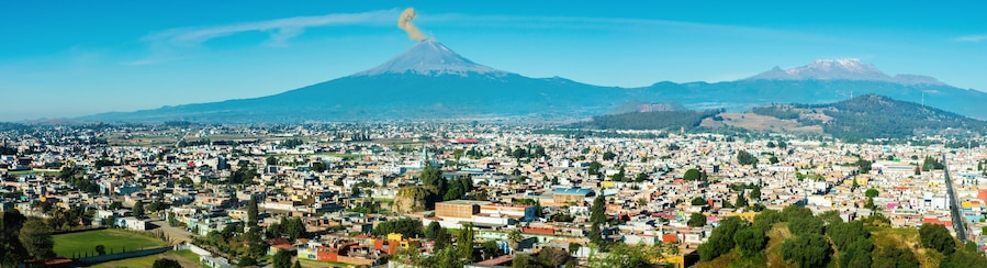 Eruption of Popocatepetl Volcano over the town of Puebla, Mexico, panoramic view