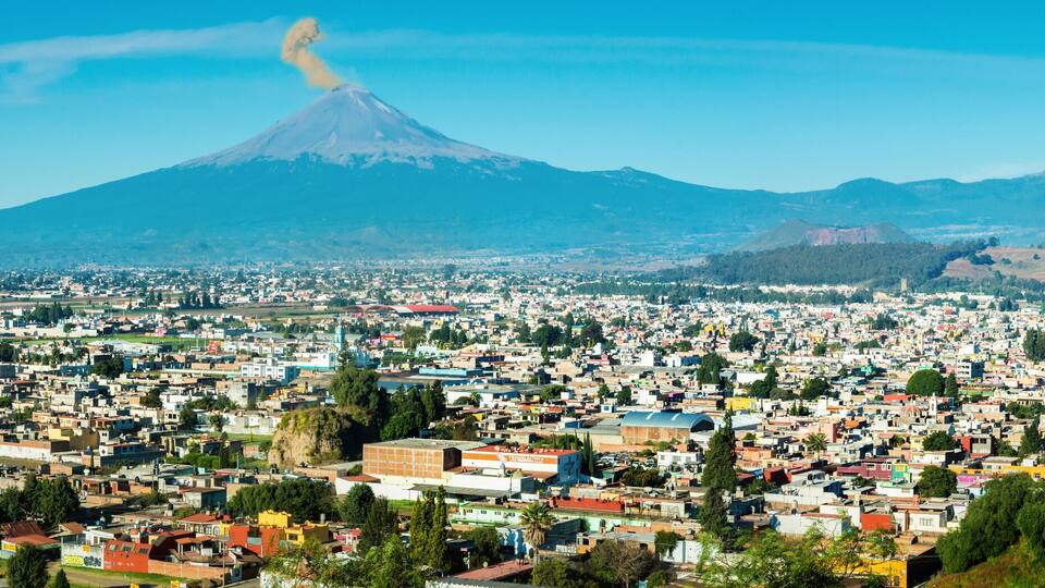 Eruption of Popocatepetl Volcano over the town of Puebla, Mexico, panoramic view