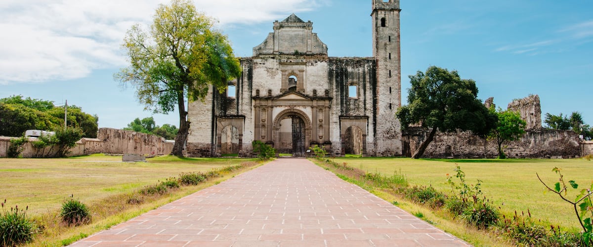 Front view of a old church with a garden