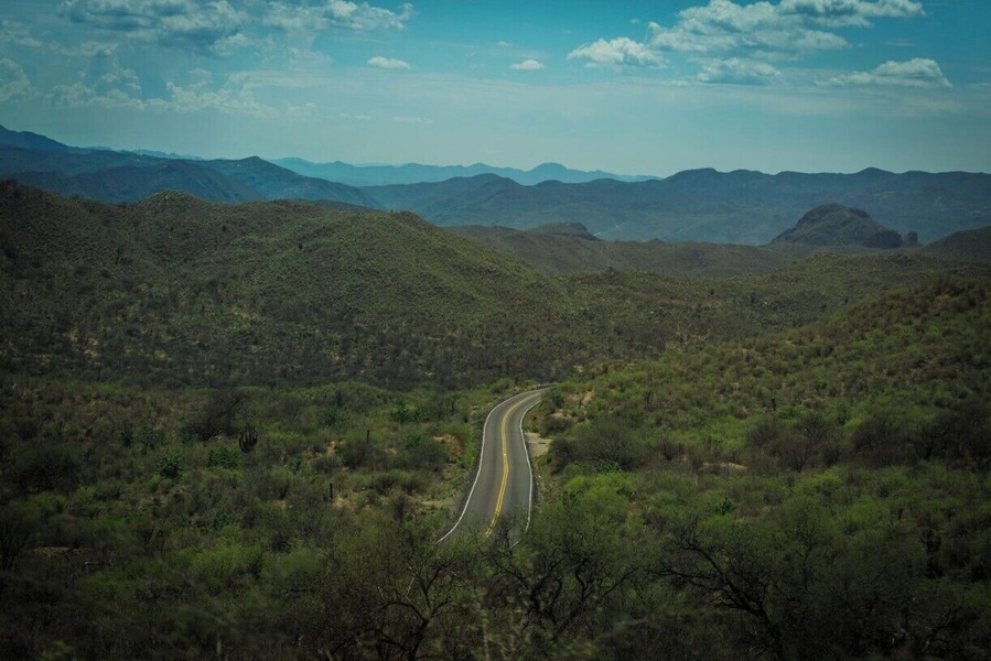 As you drive through the Sierra Sonorense, the road can sometimes get lost behind the mountains.