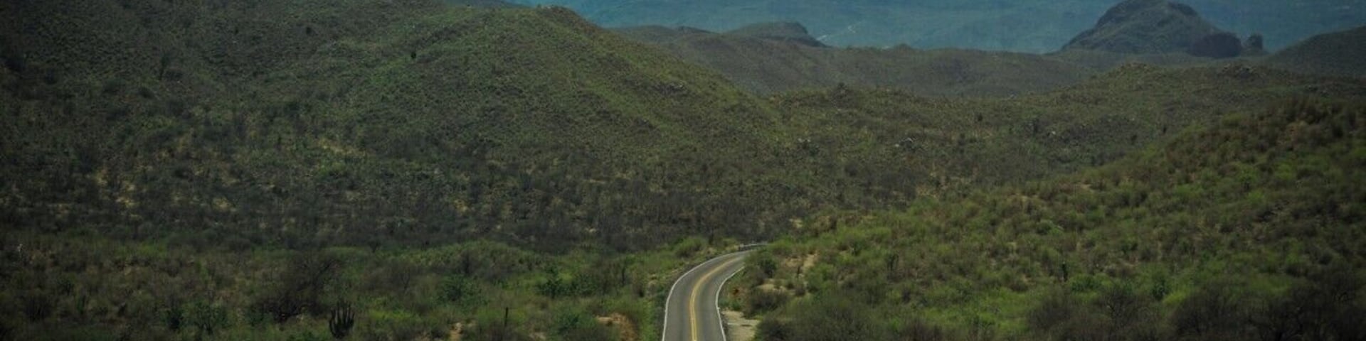 As you drive through the Sierra Sonorense, the road can sometimes get lost behind the mountains.