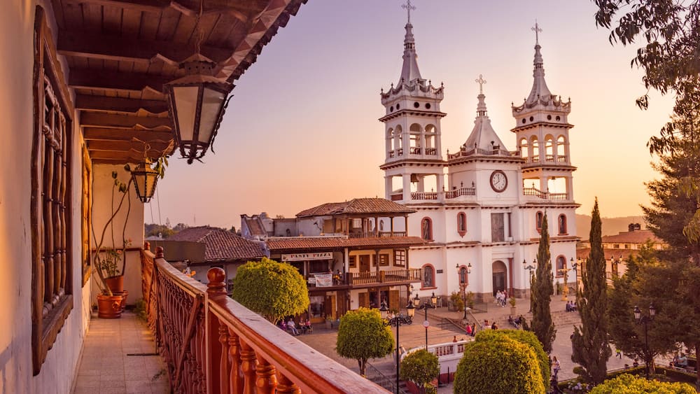 A historic church with three towers and a courtyard.