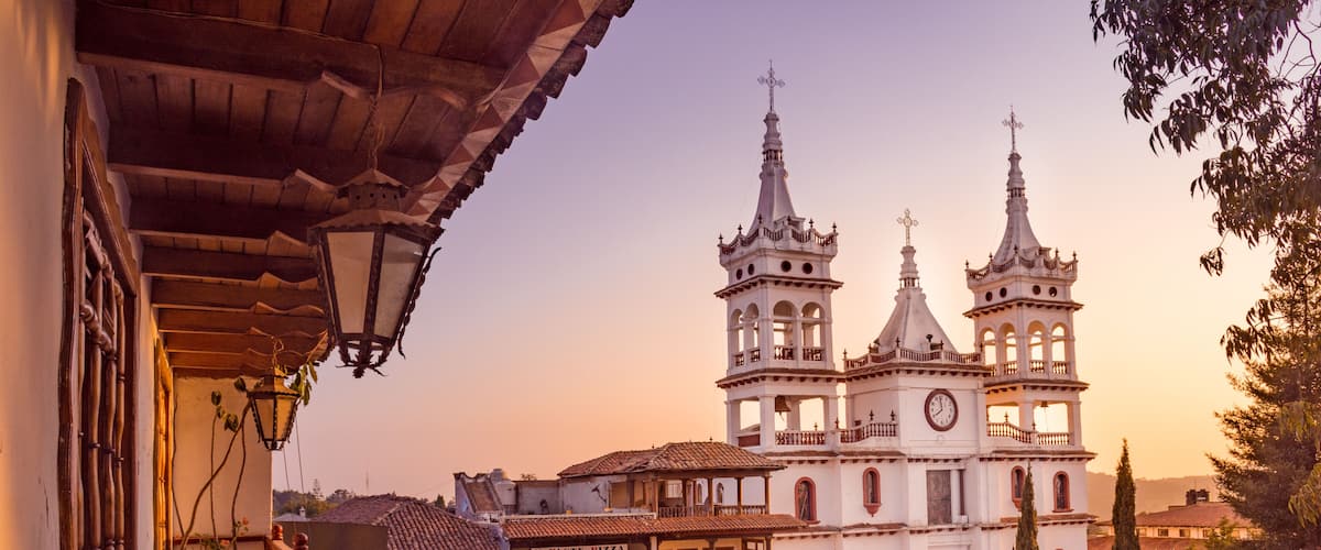 A historic church with three towers and a courtyard.