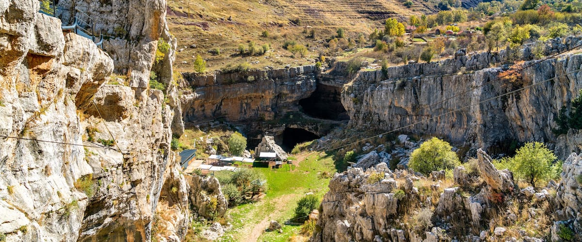 A rocky gorge with a small settlement at its base.
