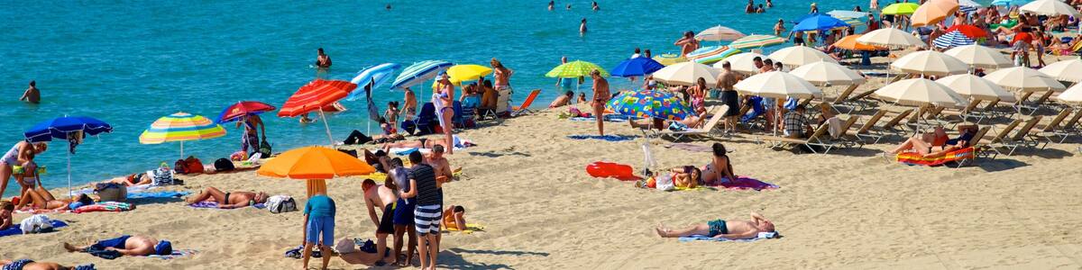 Barcelona showing swimming and a beach as well as a large group of people