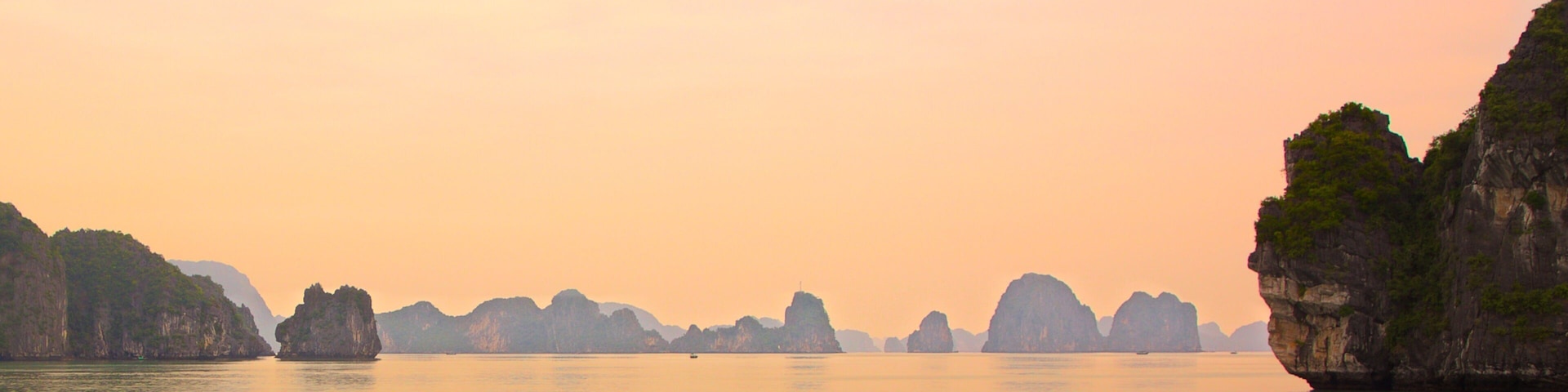 Halong Bay featuring island views, a sunset and landscape views