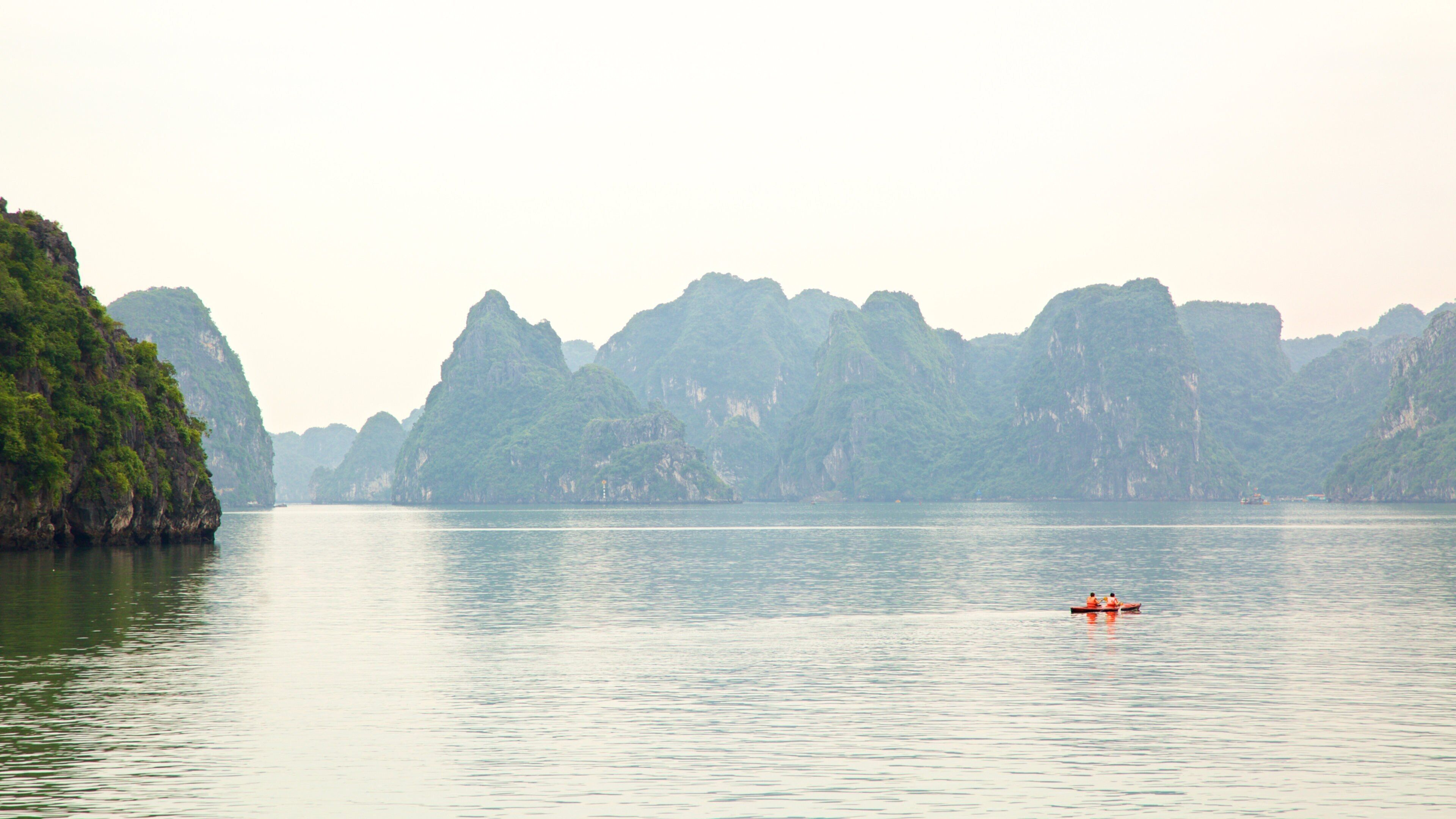 Halong Bay featuring island images and kayaking or canoeing