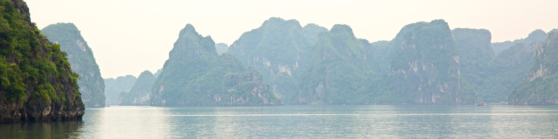 Halong Bay featuring island images and kayaking or canoeing