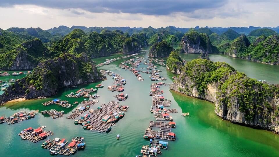 Floating fishing village and rock island in " Lan Ha " Bay, Vietnam, Southeast Asia. UNESCO World Heritage Site. Landscape. Popular landmark, famous destination of Vietnam. Near " Ha Long " bay