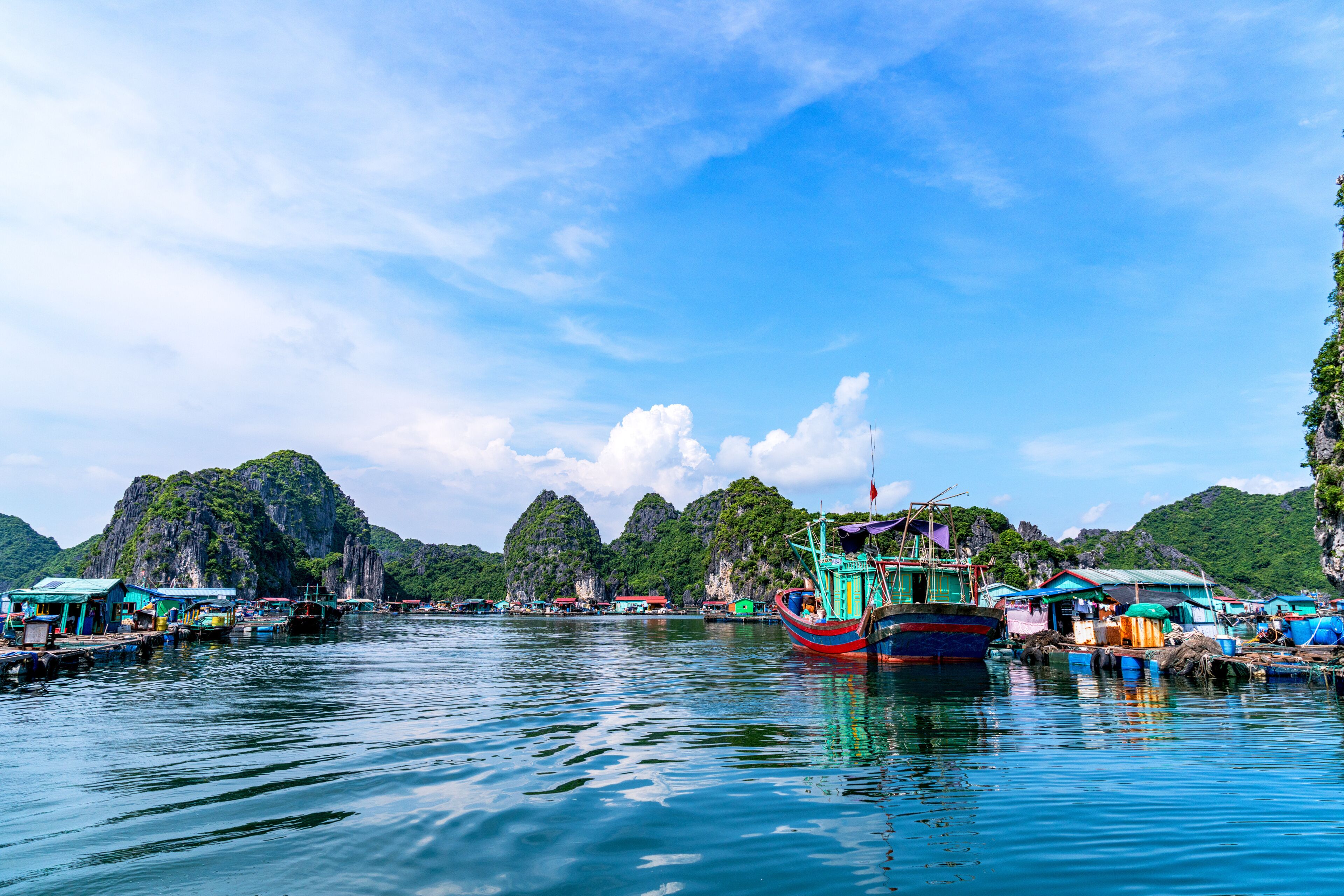 Floating fishing village and rock island in " Lan Ha " Bay, Vietnam, Southeast Asia. UNESCO World Heritage Site. Landscape. Popular landmark, famous destination of Vietnam. Near " Ha Long " bay