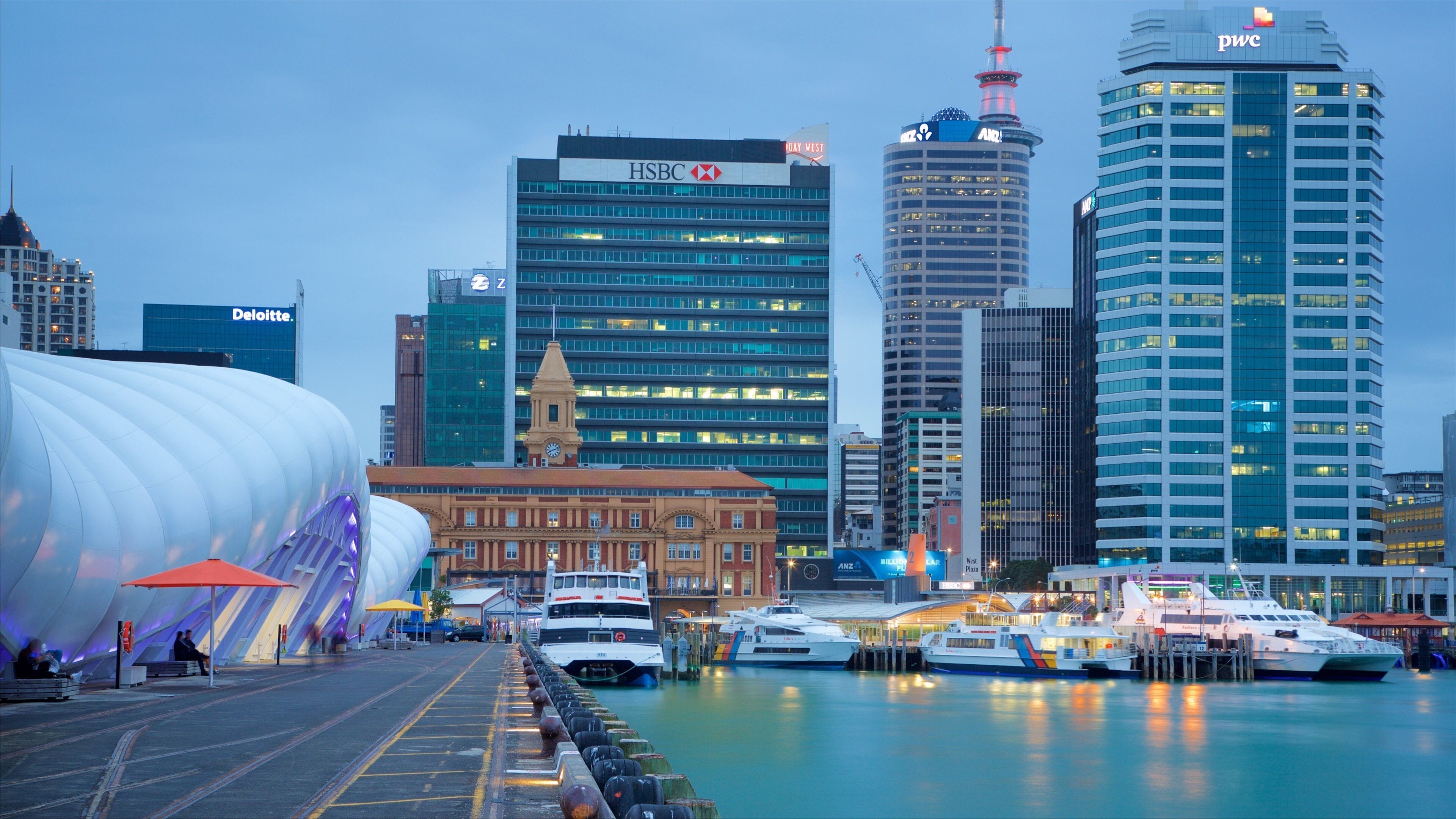 A waterfront with modern buildings, including HSBC and ANZ, and a large white structure.