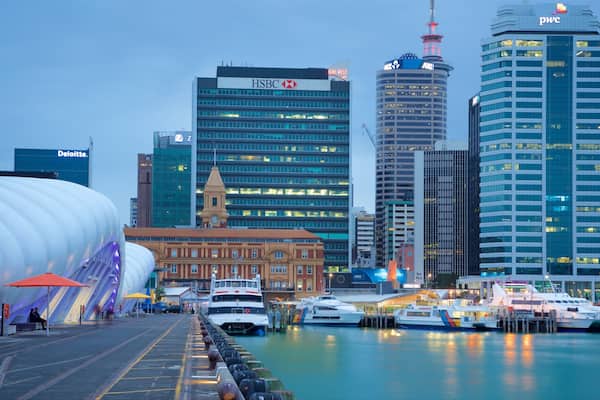 A waterfront with modern buildings, including HSBC and ANZ, and a large white structure.
