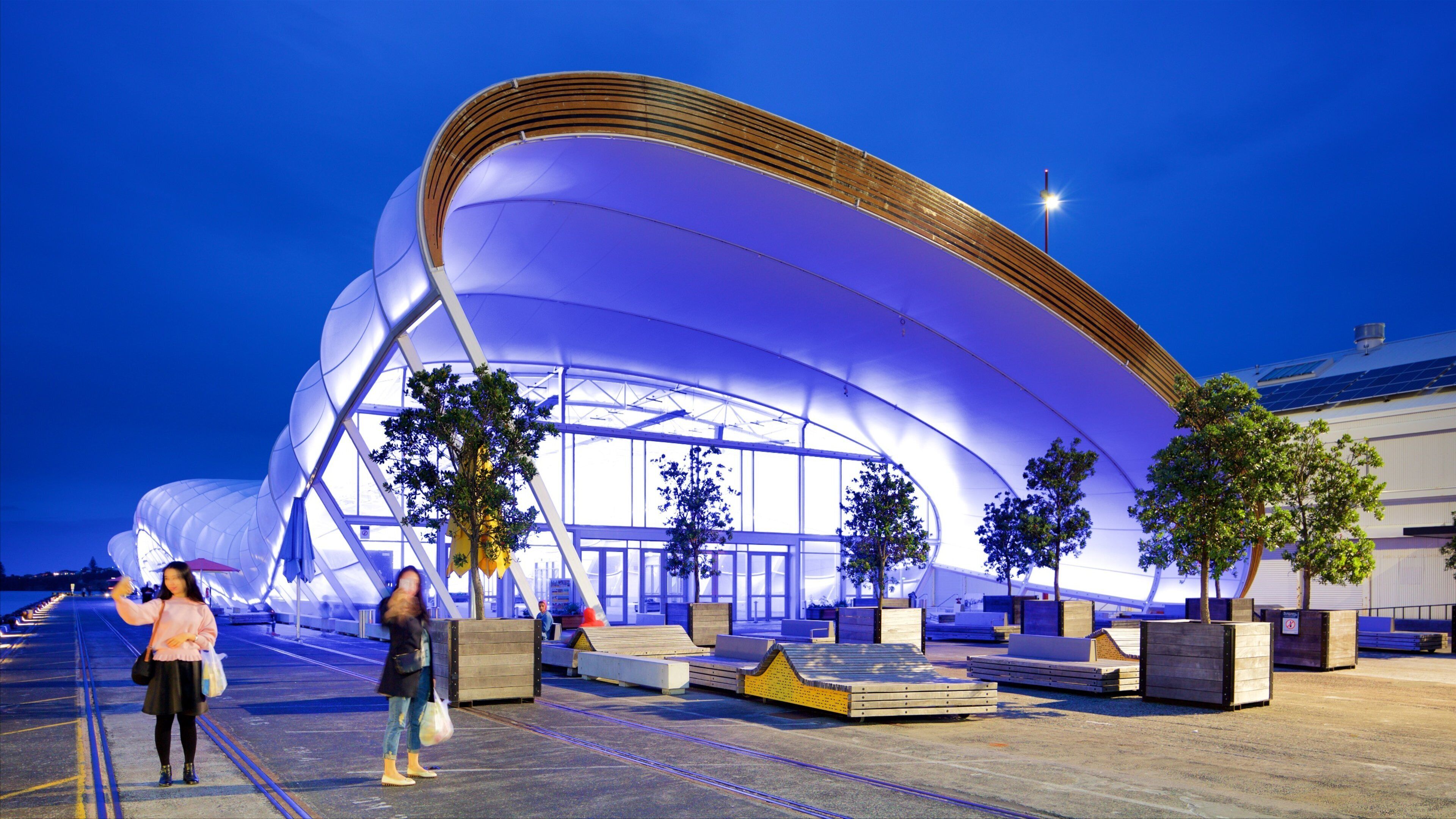 Queens Wharf featuring modern architecture and night scenes as well as a couple