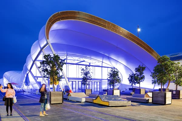 Queens Wharf featuring modern architecture and night scenes as well as a couple