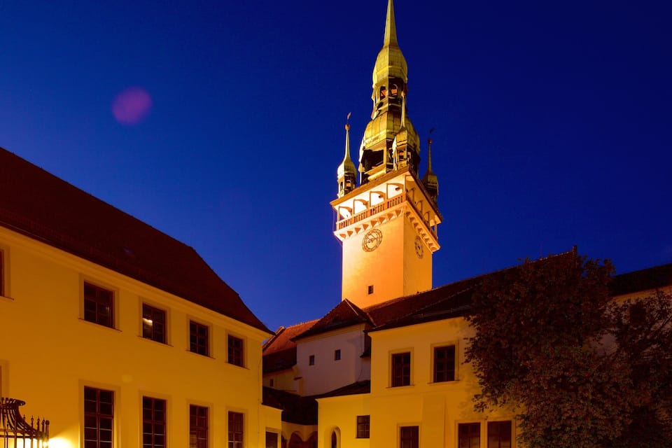 A historic building with a clock tower and a spire.