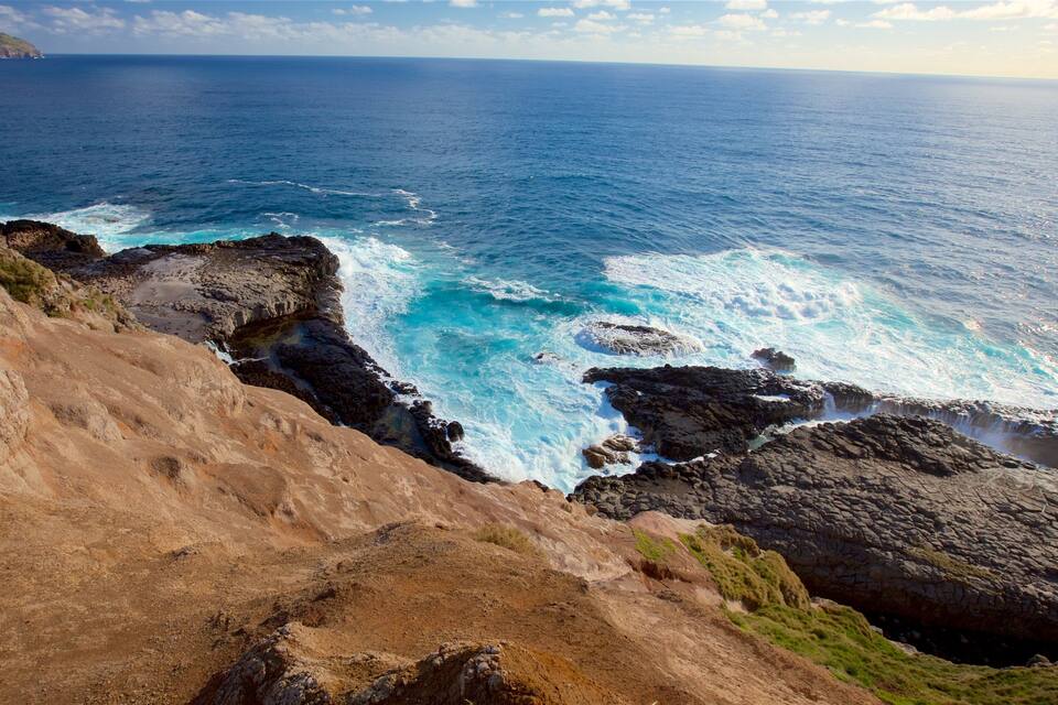 A coastal landscape with rocky cliffs and the ocean.