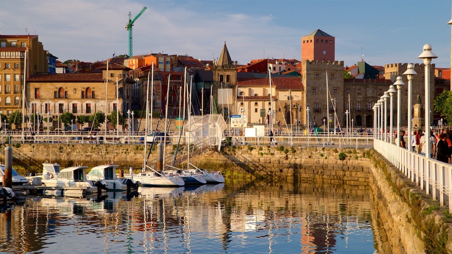 Gijon featuring a bay or harbor, a city and a sunset